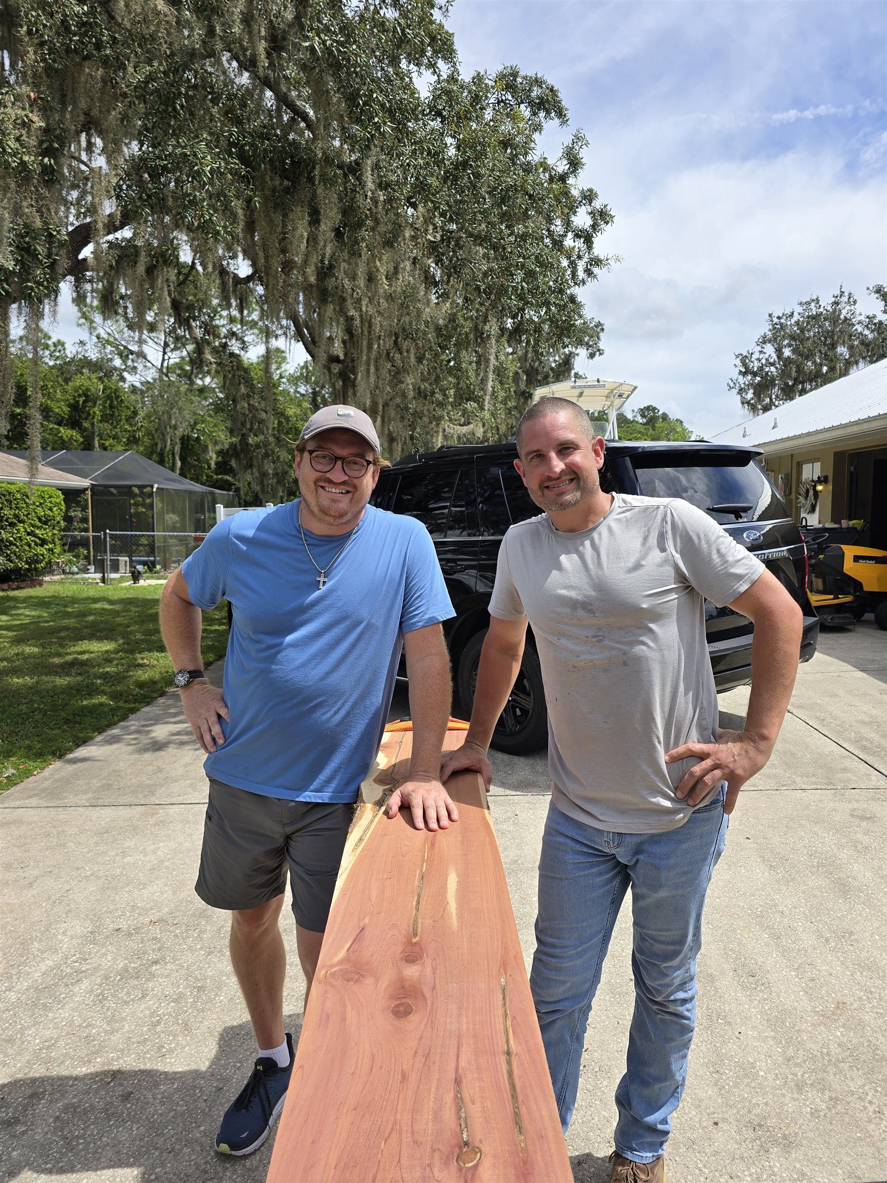 Dante and Josh LaTerra, founders of Goodwood Direct, holding a cedar board